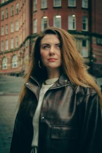 Photo of Cherie D'Avino, in celebration of her new track release, 'Hell's Kitchen', reviewed by Joanna Long, Echoes In Ink.