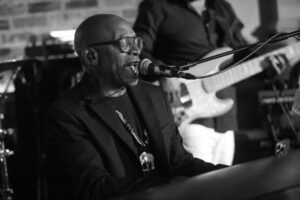 Photo of Brian Jackson performing at Pilgrim, Newcastle, on the 29th August 2026, taken by Ian Winston Coult, and used with permission for the gig review by Joanna Long of Echoes In Ink