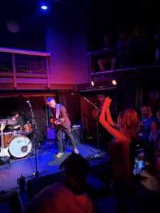 Photo of Lucca Mae watching her band from the audience during her set at The Cluny in Newcastle September 2026