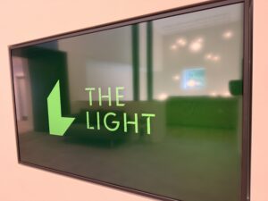 Photo of the branding for The Light at the entrance to one of the exhibition rooms