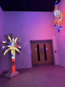 Photo of Yto Barrada's 'Palm Sign' 2010 and Chila Burman's 'Hanging Monkey' 2022/2026, installed in The Light, Durham as part of the Victory Over The Sun: Encounters With Light exhibition, August 2026